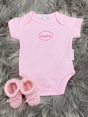 pink embroidered baby grow and knitted booties