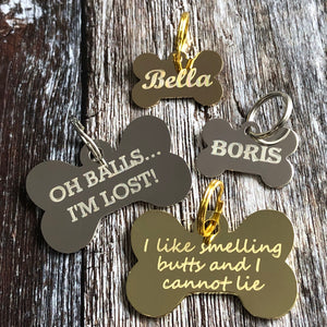 gold and silver bone dog tags